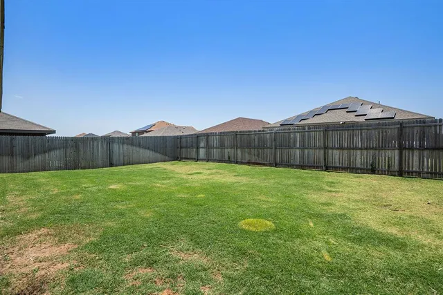 a view of a backyard with a table and a chair