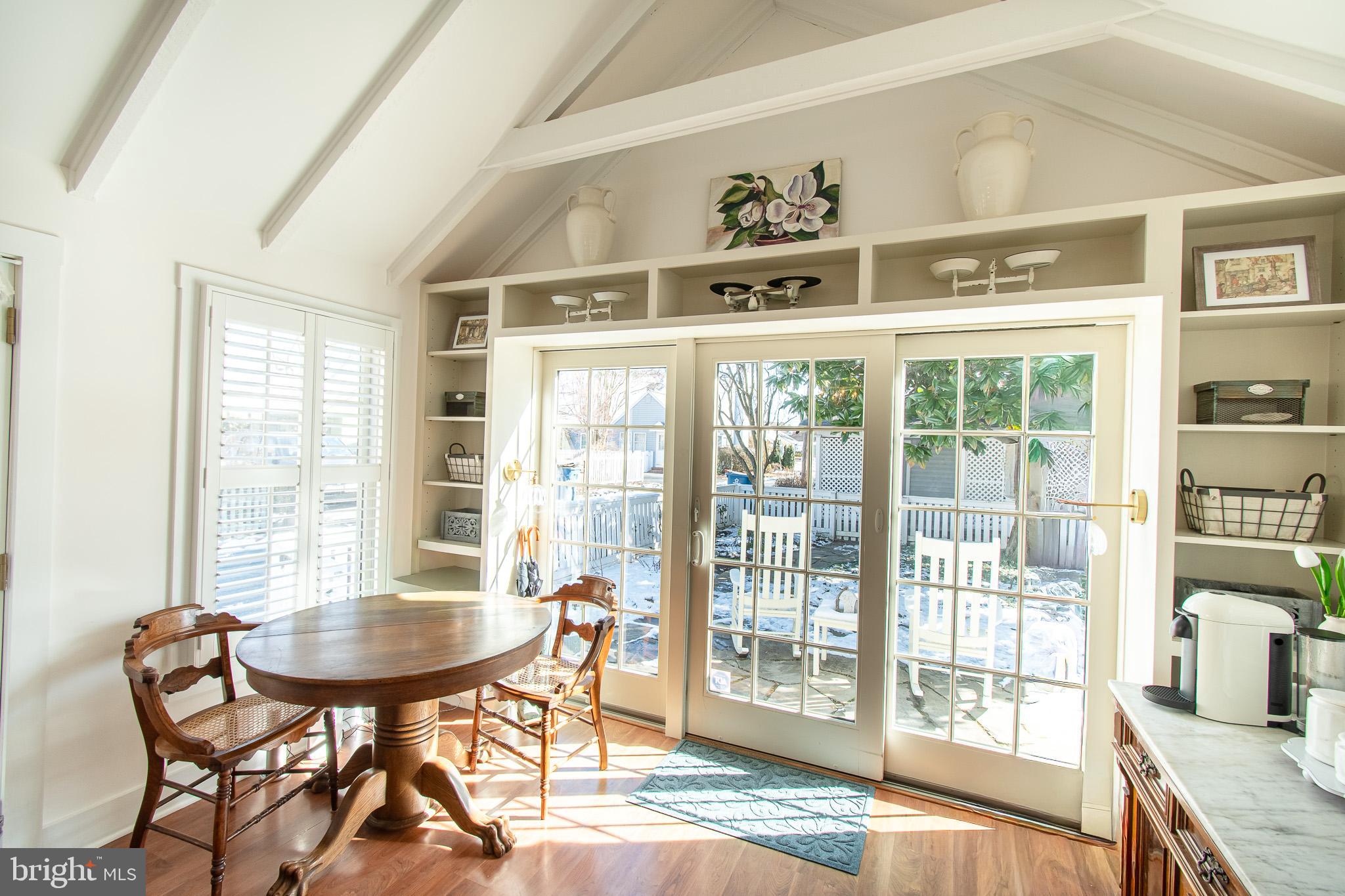 114 East Chew Avenue St. Michaels, MD 21663 - Photo 16 of 57 a dining room with furniture large windows and wooden floor