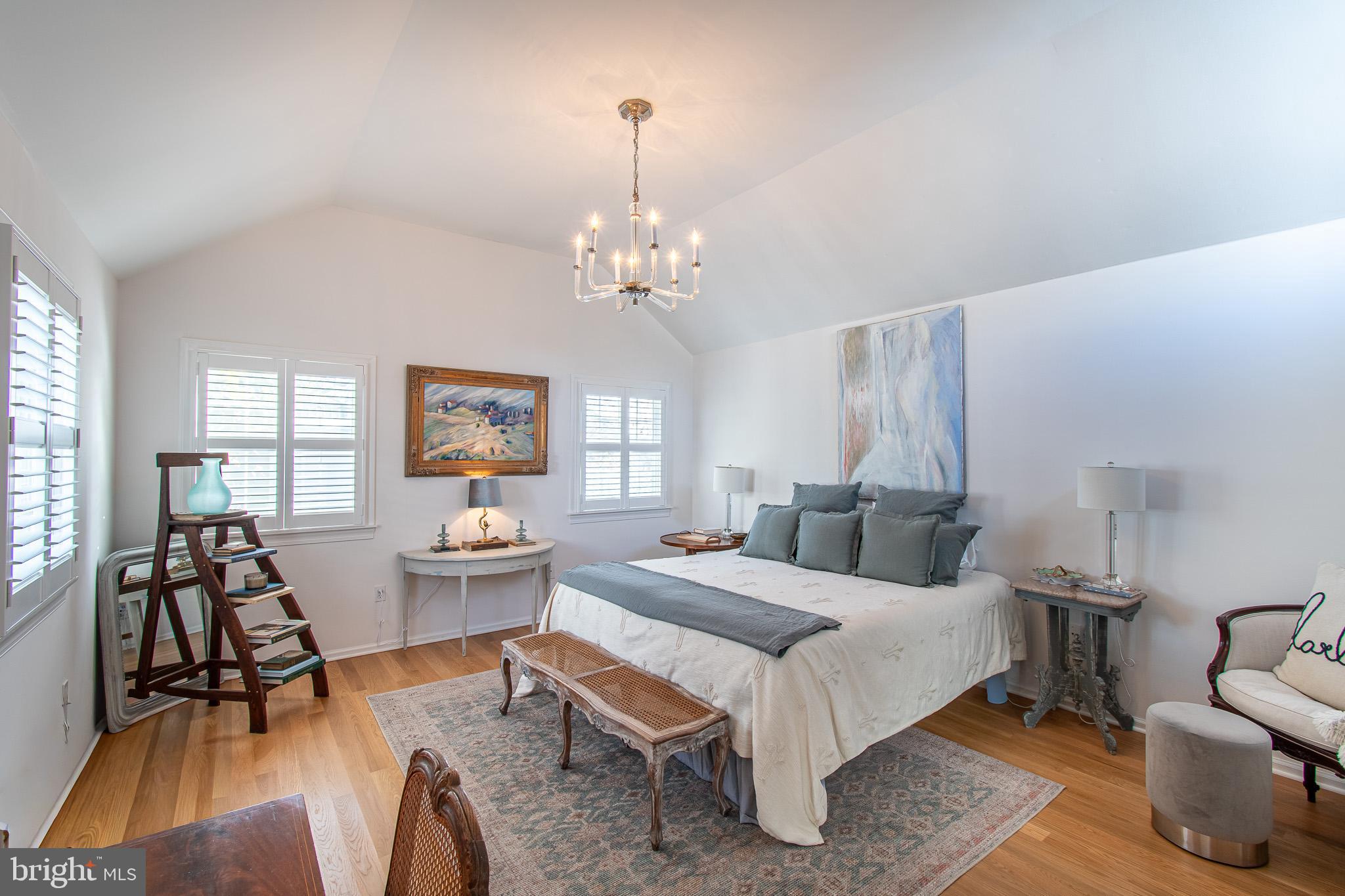 114 East Chew Avenue St. Michaels, MD 21663 - Photo 23 of 57 a bedroom with a bed and a chandelier