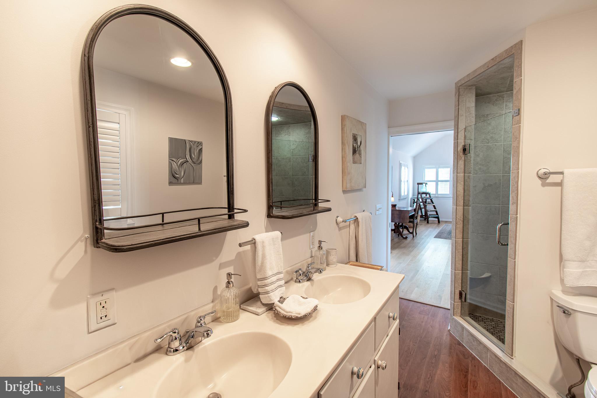 114 East Chew Avenue St. Michaels, MD 21663 - Photo 25 of 57 a en suite bathroom with a double vanity sink and a mirror