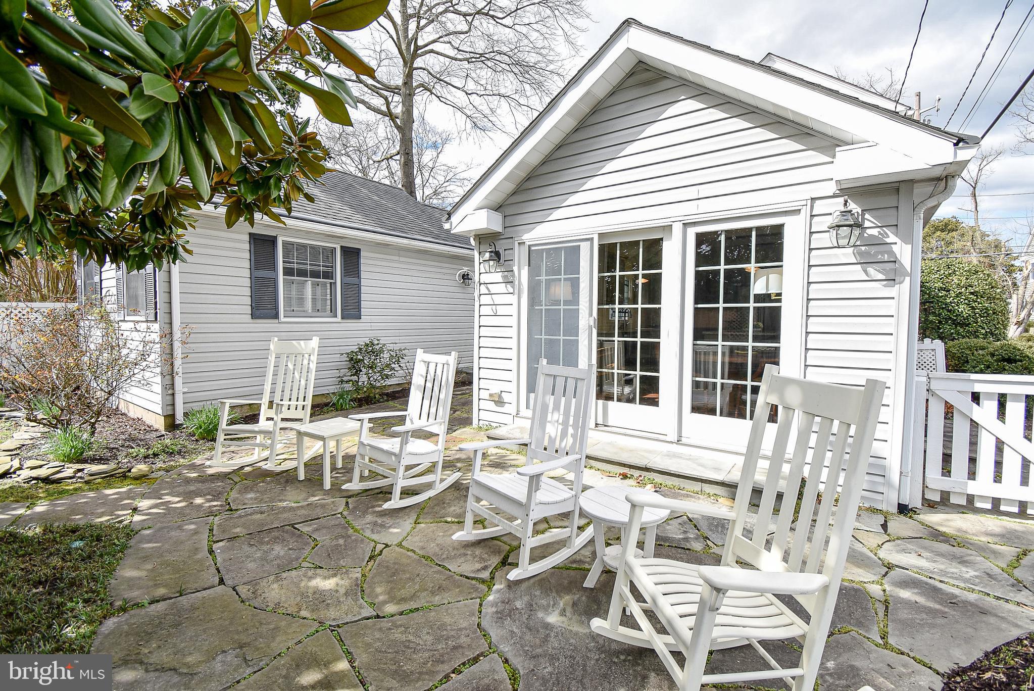 114 East Chew Avenue St. Michaels, MD 21663 - Photo 32 of 57 a view of a patio with table and chairs and potted plants