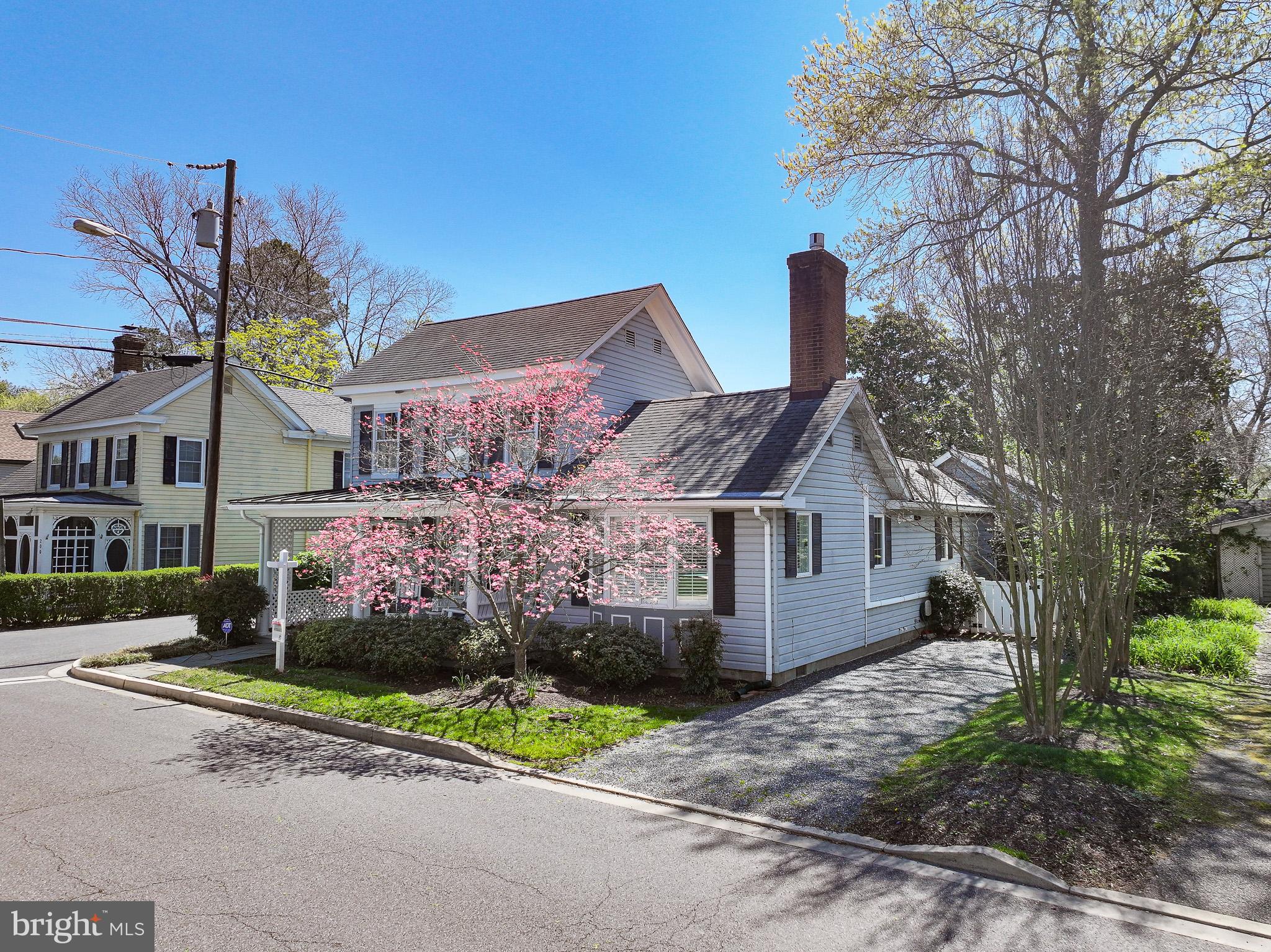 114 East Chew Avenue St. Michaels, MD 21663 - Photo 51 of 57 a front view of a house with a yard and a garage