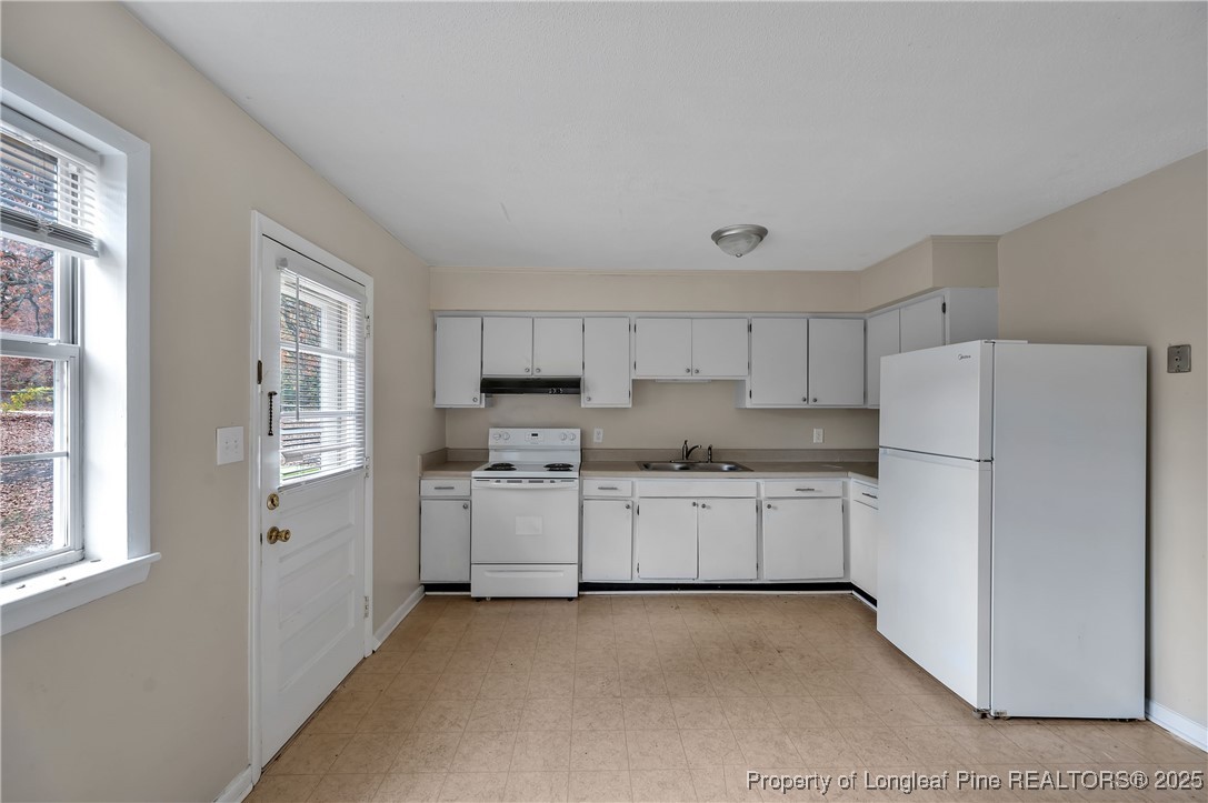 302 Law Road, Unit A Fayetteville, NC 28311 - Photo 2 of 8 a kitchen with stainless steel appliances a refrigerator sink and stove