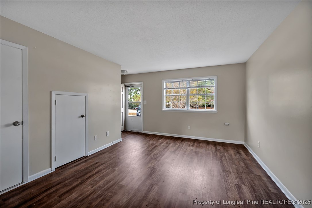 302 Law Road, Unit A Fayetteville, NC 28311 - Photo 4 of 8 an empty room with wooden floor and windows