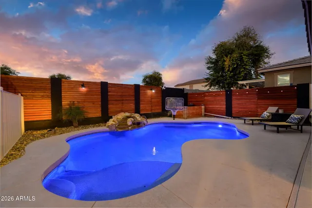 a view of a swimming pool with outdoor seating