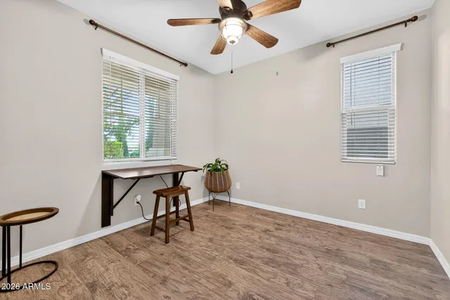 a view of a workspace with furniture and a window