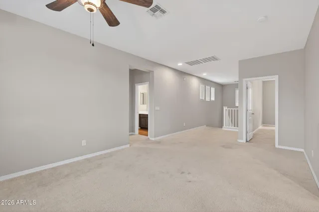 a view of an empty room with a ceiling fan