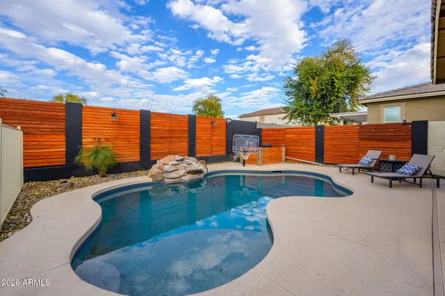a view of a swimming pool with furniture