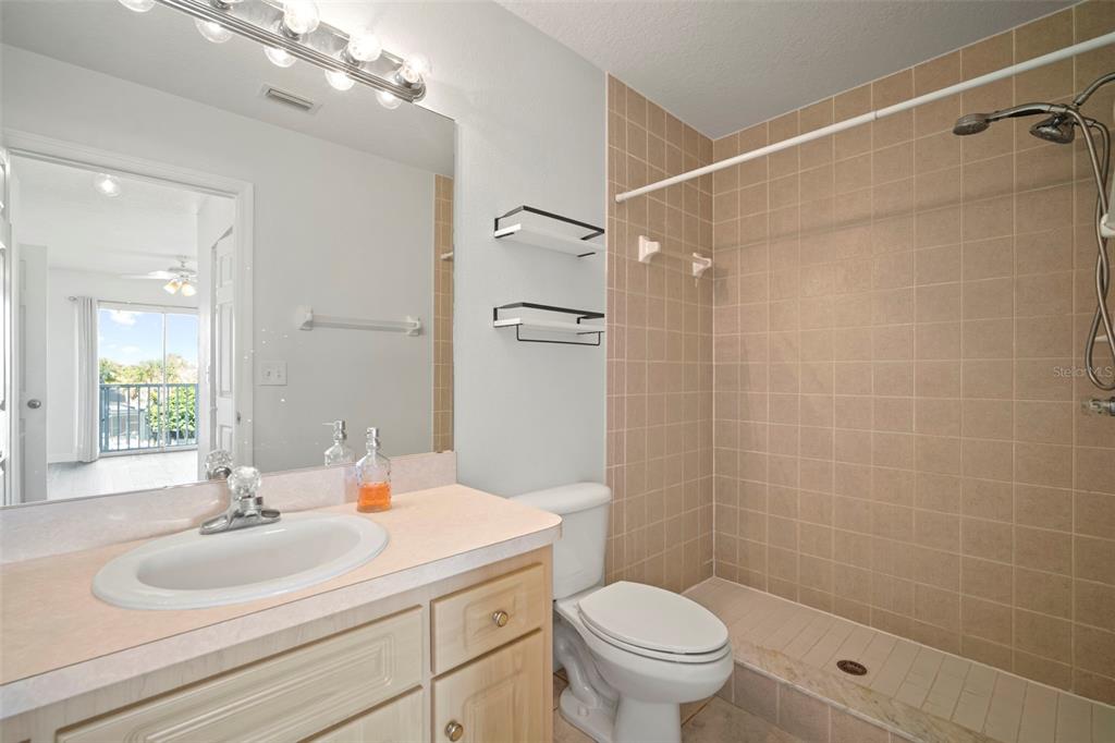 1013 Apollo Beach Boulevard, Unit 203 Apollo Beach, FL 33572 - Photo 24 of 26 a bathroom with a sink toilet a mirror and shower