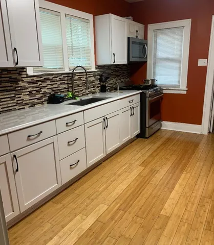 a kitchen with white cabinets