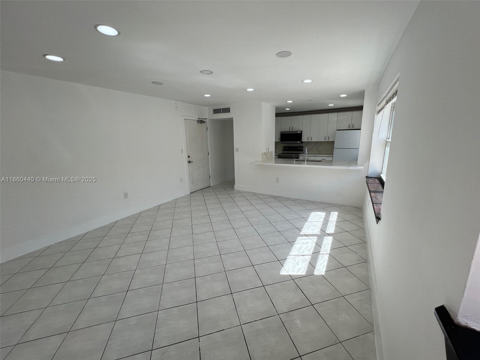 1308 Drexel Avenue, Unit 103 Miami Beach, FL 33139 - Photo 15 of 37 wooden floor in an empty room with a window