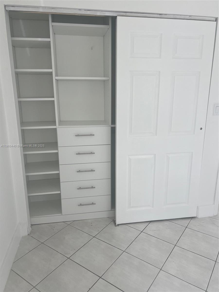 1308 Drexel Avenue, Unit 103 Miami Beach, FL 33139 - Photo 31 of 37 a view of walk in closet with empty racks