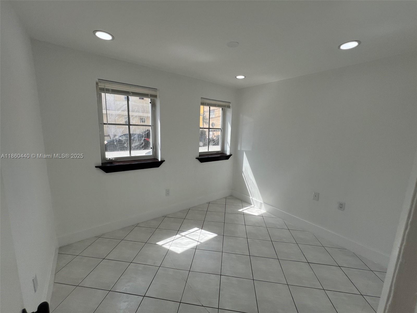 1308 Drexel Avenue, Unit 103 Miami Beach, FL 33139 - Photo 32 of 37 a view of empty room with windows