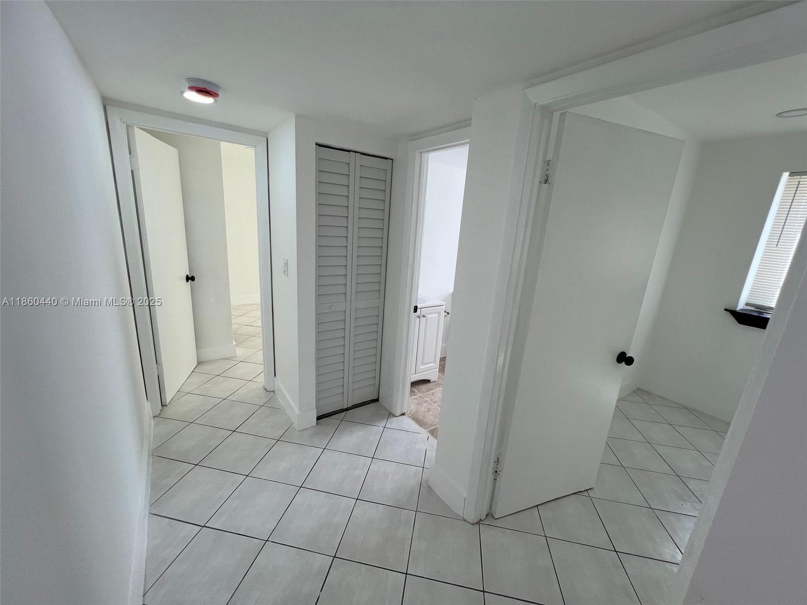 1308 Drexel Avenue, Unit 103 Miami Beach, FL 33139 - Photo 35 of 37 a view of entryway with white walls and tiles