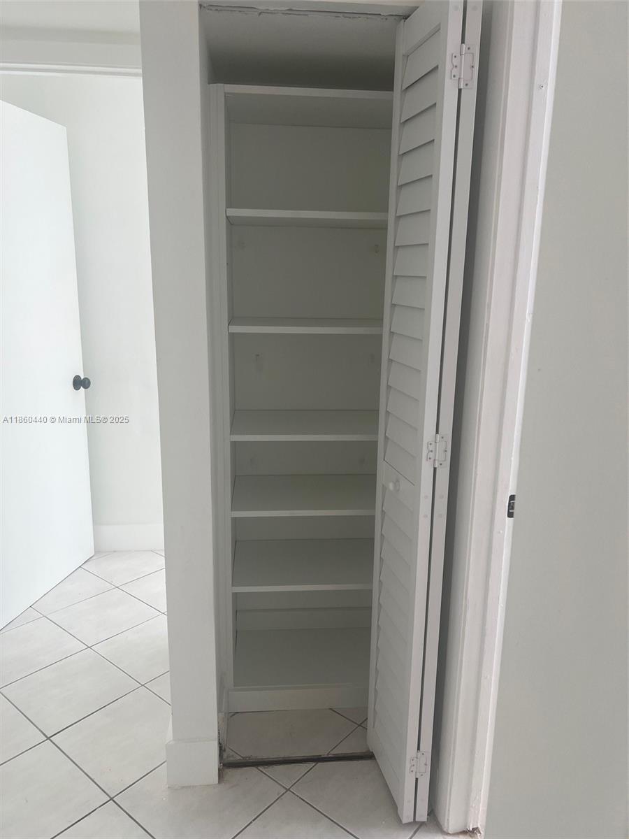1308 Drexel Avenue, Unit 103 Miami Beach, FL 33139 - Photo 36 of 37 a view of walk in closet with empty racks
