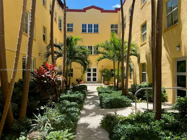 a front view of a multi story residential apartment building with a yard