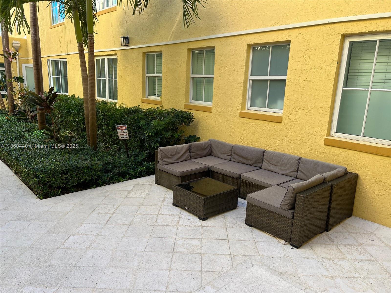 1308 Drexel Avenue, Unit 103 Miami Beach, FL 33139 - Photo 10 of 37 a view of a patio with couches chairs and potted plants