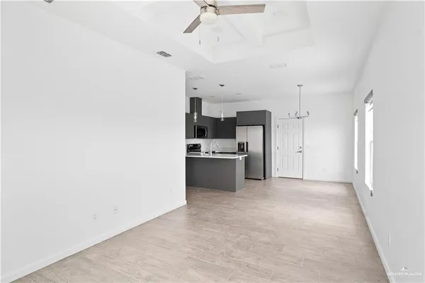 a view of a kitchen with a sink and a refrigerator