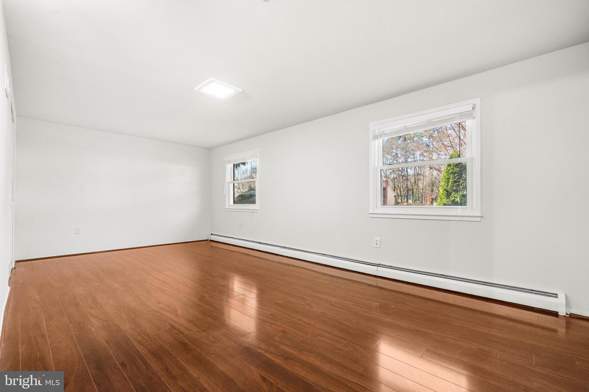 13411 Kerrydale Road Woodbridge, VA 22193 - Photo 13 of 44 a view of an empty room with wooden floor and a window
