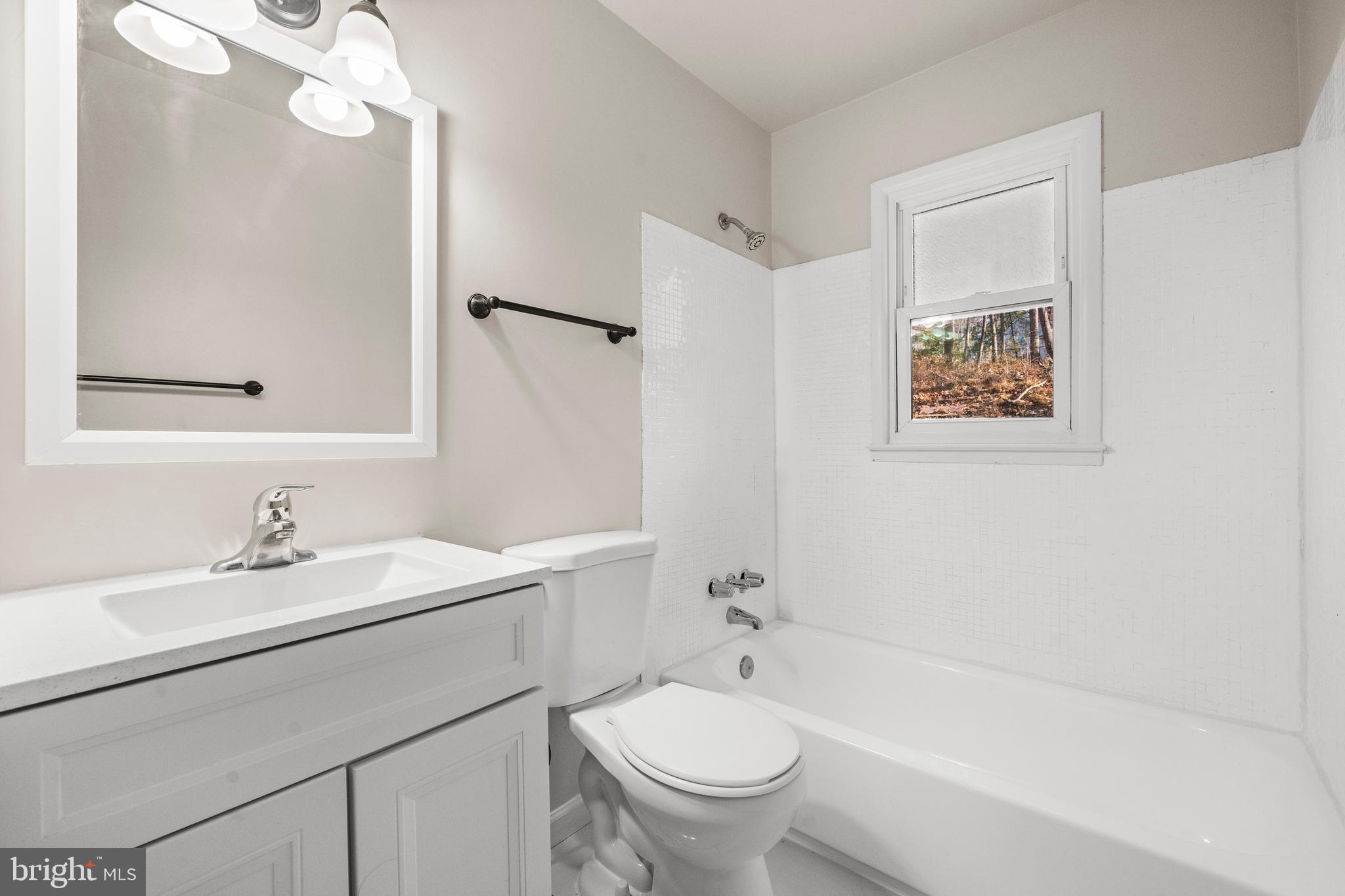 13411 Kerrydale Road Woodbridge, VA 22193 - Photo 24 of 44 a bathroom with a sink a toilet and shower