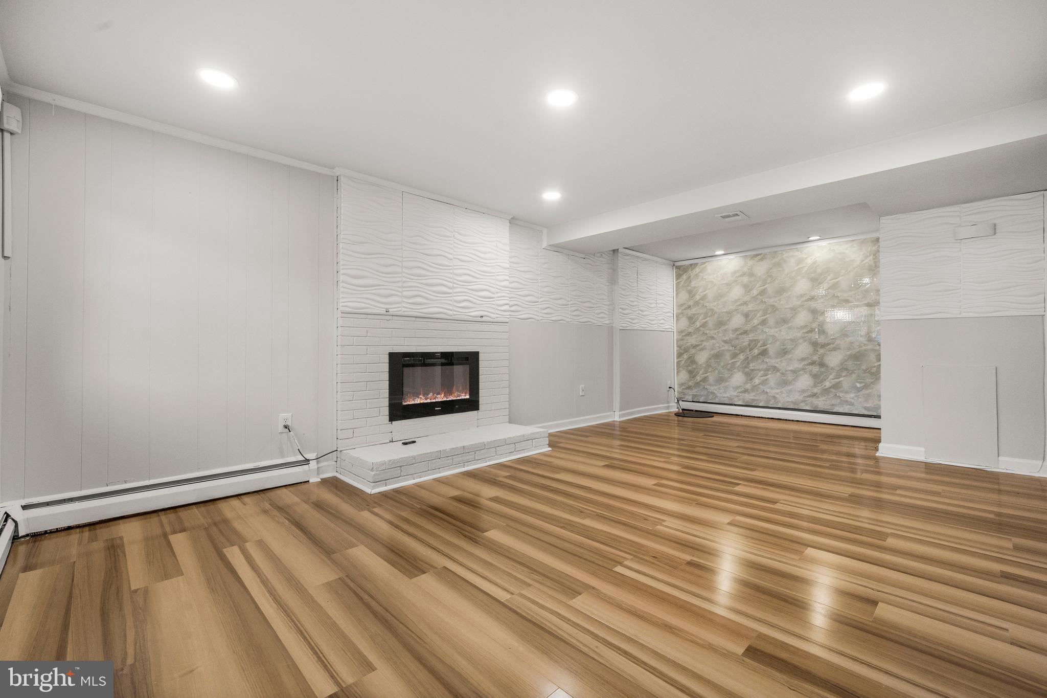 13411 Kerrydale Road Woodbridge, VA 22193 - Photo 26 of 44 an empty room with wooden floor and fireplace