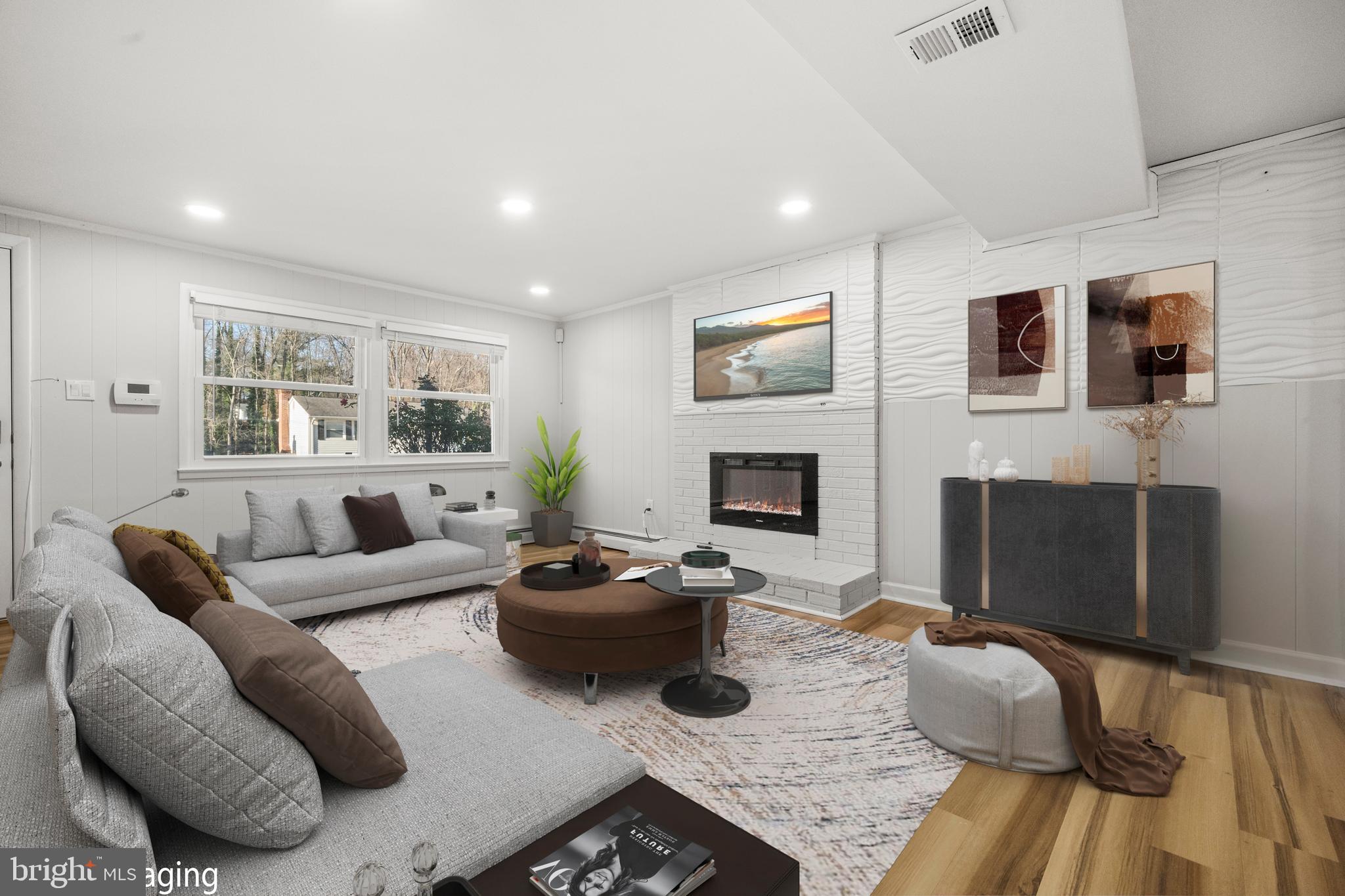 13411 Kerrydale Road Woodbridge, VA 22193 - Photo 29 of 44 a living room with furniture a fireplace and a flat screen tv