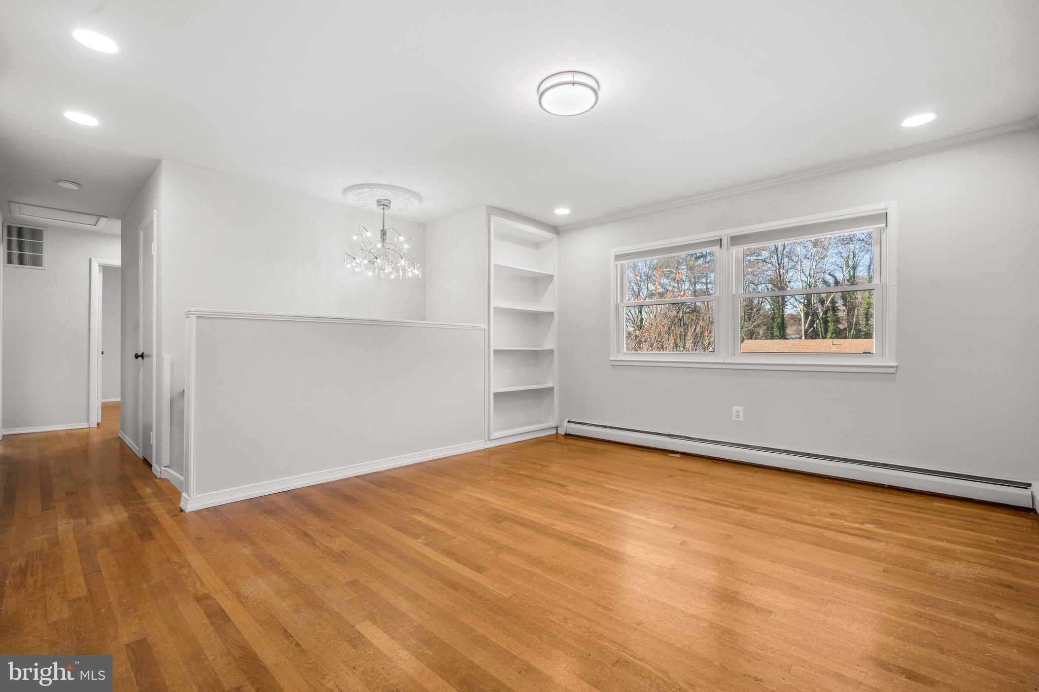 13411 Kerrydale Road Woodbridge, VA 22193 - Photo 5 of 44 a view of an empty room with a window and wooden floor