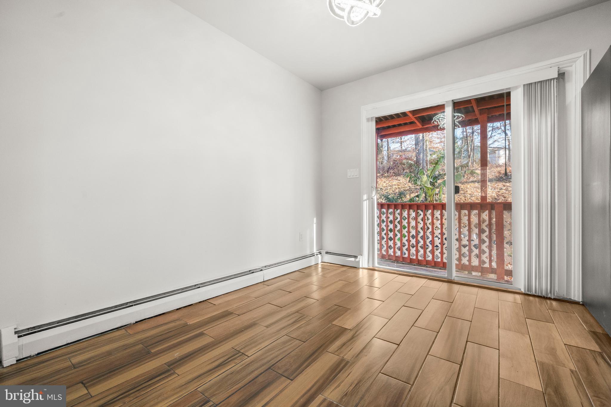 13411 Kerrydale Road Woodbridge, VA 22193 - Photo 6 of 44 an empty room with wooden floor and windows