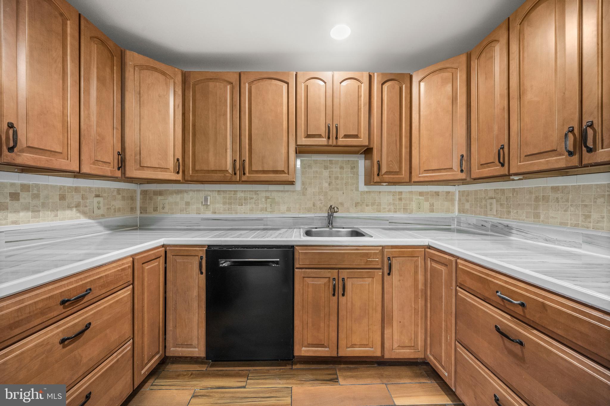 13411 Kerrydale Road Woodbridge, VA 22193 - Photo 10 of 44 a kitchen with stainless steel appliances granite countertop a sink a stove cabinets and a counter space