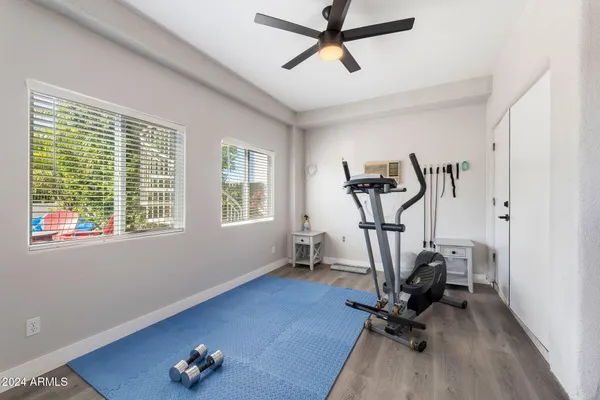 a bathroom with a granite countertop toilet a sink and a large mirror