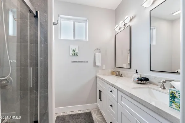 a bedroom with two beds and a chandelier