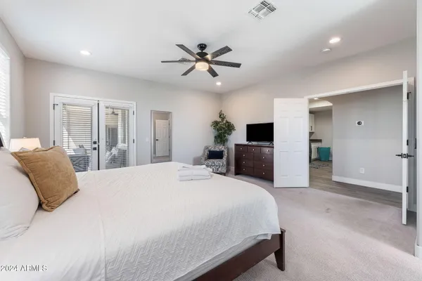 a spacious bedroom with a bed and a window