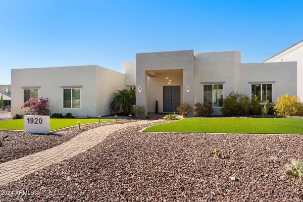 a view of a house with a backyard and a garden