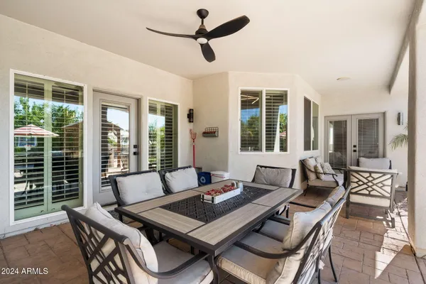 a view of a patio with couches chairs and potted plants