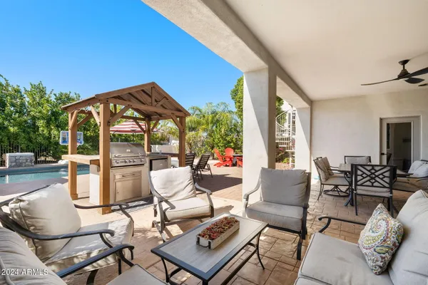 a view of a house with pool and chairs