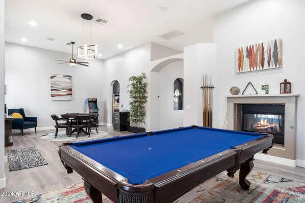 a room with pool table and windows