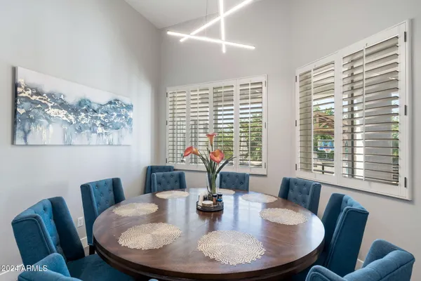 a dining room with furniture and wooden floor