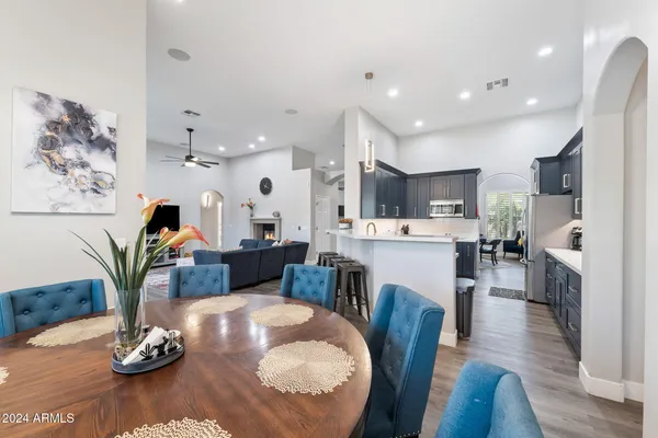 a living room with furniture kitchen view and a fireplace