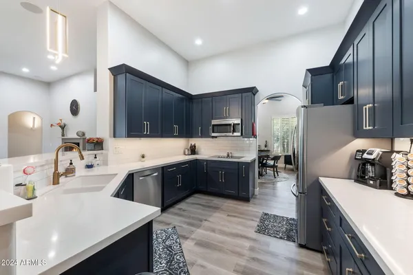 a kitchen with granite countertop stainless steel appliances and wooden cabinets