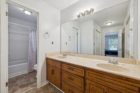 a view of a room with wooden floor and windows