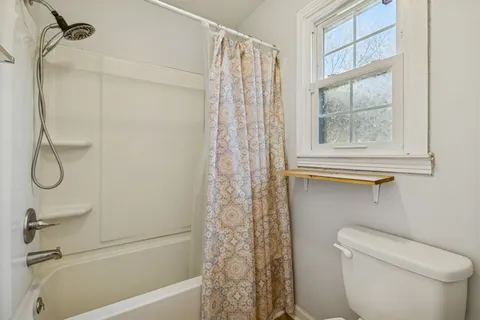 a spacious bedroom with a bed and a window