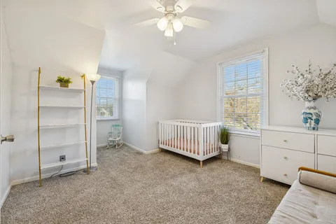 a bath tub sitting next to a white curtain