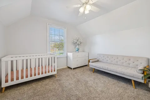 a bedroom with furniture and a large window