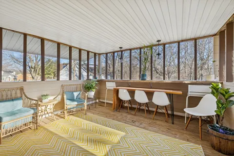 a view of a chairs and table in the balcony
