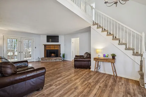 a view of a livingroom with furniture wooden floor and a chandelier