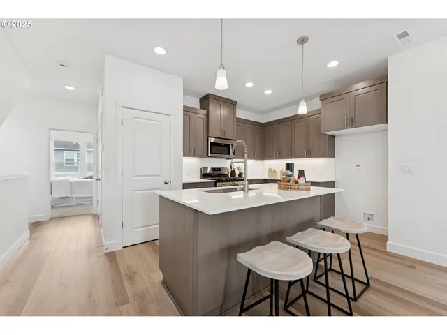 a kitchen with stainless steel appliances kitchen island granite countertop a sink and cabinets