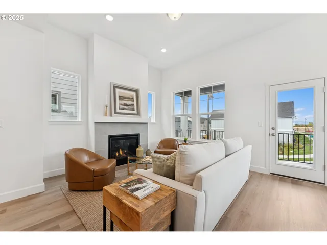 a living room with furniture a fireplace and a wooden floor