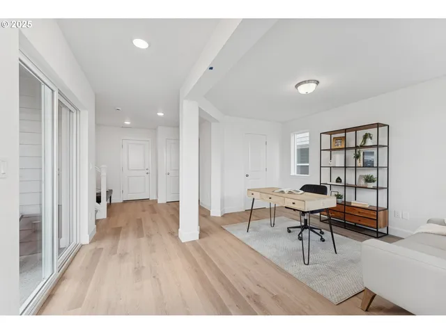 a living room with furniture a dining table and wooden floor