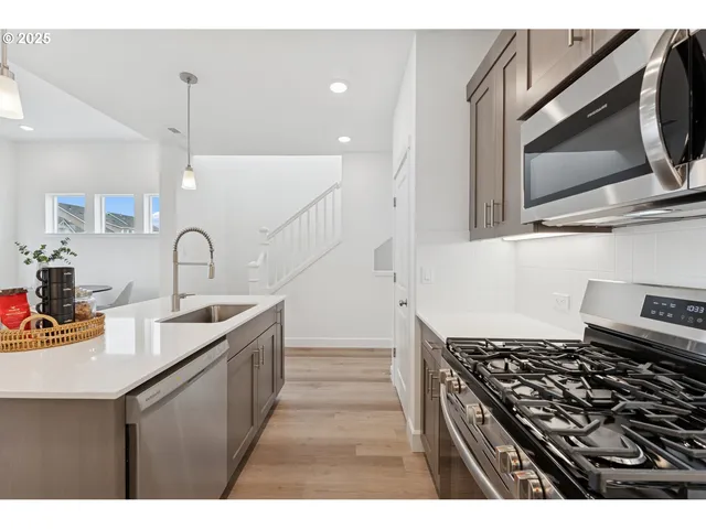 a kitchen with a sink stove and microwave