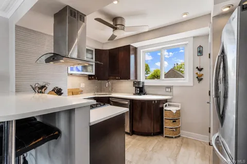 a kitchen with stainless steel appliances a sink stove and refrigerator